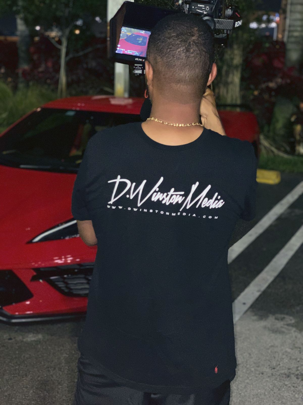 Dwight in a D. Winston Media shirt on a night car shoot